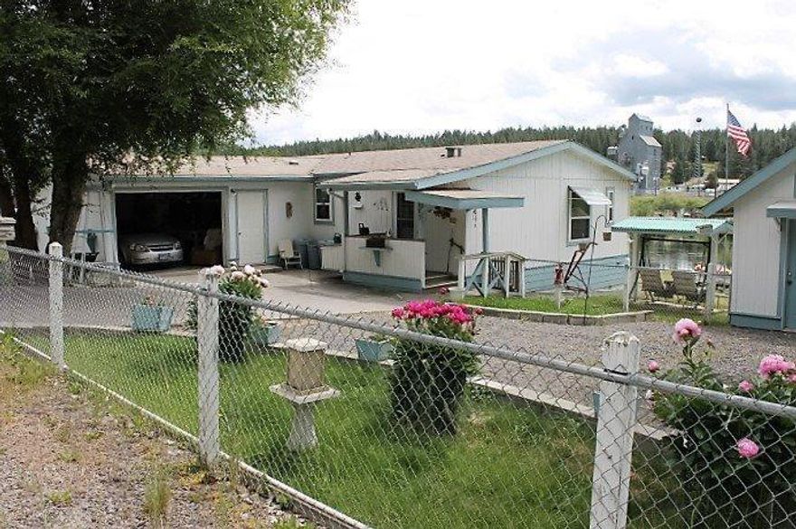 Lovely 2 bed/2bath manufactured home with 100' of world renowned Williamson River frontage could be yours! This home features two single car garages; one is oversized and is attached to the home with a workshop to one side + roll up doors on both ends for pull through access, the other is detached with an overhead opener and its own driveway. This was a 3 bedroom, but one of the rooms was converted to accommodate entertaining into a dining space with a nice buffet for serving while hosting at your own private park on the river. If needed it could be converted back to a bedroom. There is sweet dock the river to tie up your boat, fish or swim from along with a large greenhouse and garden shed. Before health became a factor, the grounds were well loved and felt like your own private park. The grounds are completely fenced for the safety of your pets. This is sold AS-IS. Seller will not pay for any concessions, inspections for repairs.