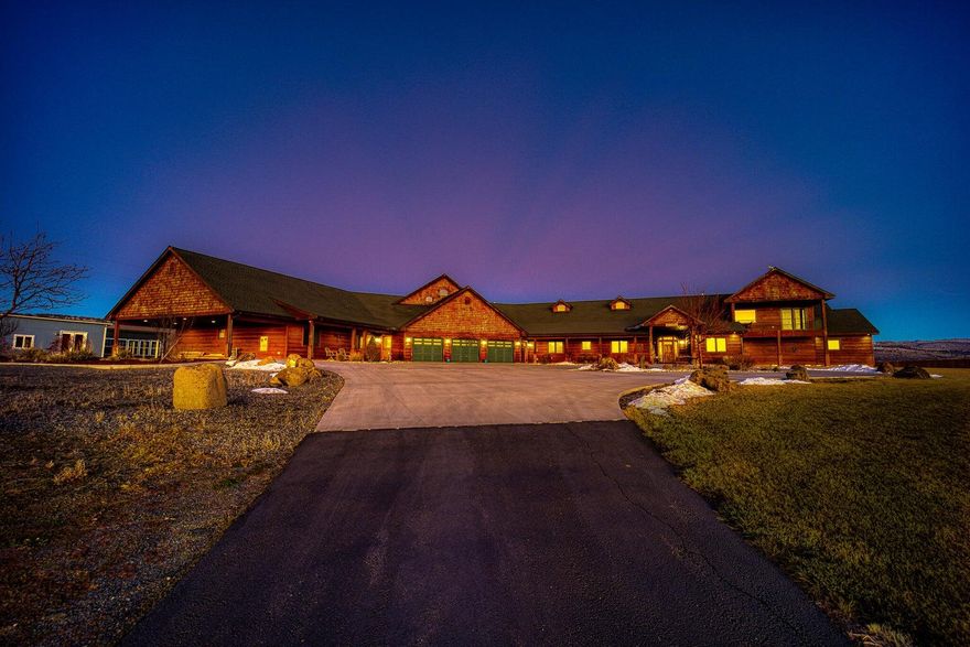 Welcome to a residence that redefines luxury living in Klamath Falls. Set on 27 irrigated acres surrounded by expansive farmland, this private retreat offers a rare blend of elegance and functionality. The main home and separate guest wing (4 bed/3 bath with private entrance) are connected by a spacious recreation room featuring a full bar, pool table, multiple TVs, and a cozy loft beneath 28' vaulted tongue-and-groove ceilings. The gourmet kitchen boasts granite countertops, alder cabinets, and stainless steel appliances, all oriented to enjoy the stunning views and open interaction with guests. The main-floor primary suite includes a fireplace, jetted tub, tile shower, and heated tile flooring. The large insulated shop, ample storage, and walk-in closets round out the property's offerings. Only 15 minutes from downtown Klamath Falls and approximately 90 minutes from commercial air travel in Medford, the estate offers both seclusion & convenience to shopping, dining, and recreation.