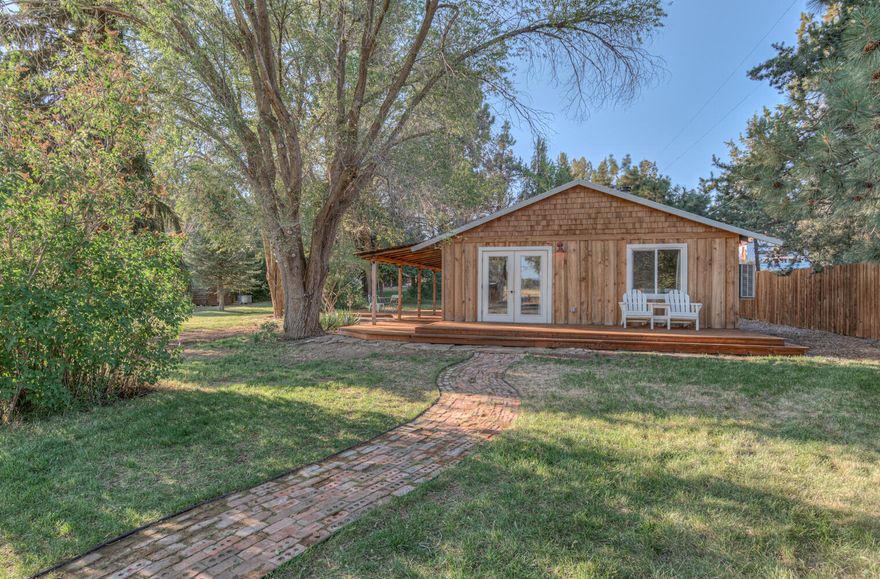 Cozy one-bedroom cabin with a loft, recently remodeled with charm. The property includes a detached 900 sq. ft. garage on over an acre in Tumalo with Swalley Irrigation rights. Close to town, yet private and spacious, this lot, zoned MUA, offers a multitude of exciting possibilities including short-term rental or a business. Buyer to verify. 

Start your day with a heated outdoor shower and a sauna, and harvest fresh veggies in the spacious garden for a barbecue under the shade of mature trees on the large deck and outdoor patio that surrounds the home. Enjoy the wood stove in the vaulted living room or take a soak in the bathtub. 
     
Fully fenced with RV parking (water and power hookups) and a detached office with power in the back. Many recent updates to the property include a custom detached shop built in 2021, a new septic system in 2020, and Avion Water installed summer of 2023.