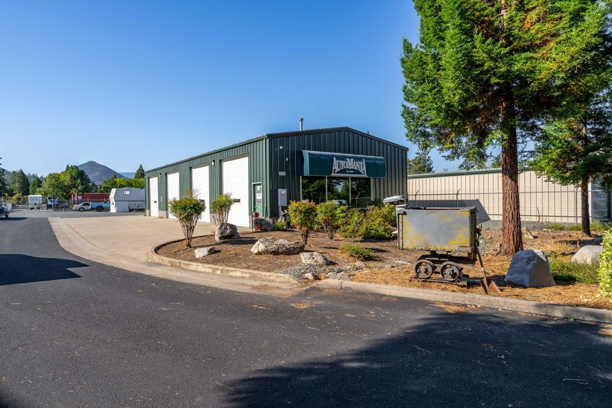 Incredible Commercial opportunity awaits at this high traffic location near I-5! This beautiful commercial property is zoned 'Business Park' and features a well-lit, fully insulated 2400 SQFT steel building with 4 large bay doors boasting a 12' clear height, 3-phase power, and an ADA restroom. You will find ample paved parking in front of the building along with mature landscaping for a beautiful and accommodating entrance. Property is fully fenced with a security gate and has city services. Additionally, this property holds unlimited opportunity for development expansion or potential RV storage with nearly 1/2 of the property primed for this business venture- including 3 full RV hookups and additional security gates/fences that separate this area from the building. Easy passive income awaits as you make this incredible property home to your business! OWNER WILL CARRY, ask about terms! Call to schedule a tour today!