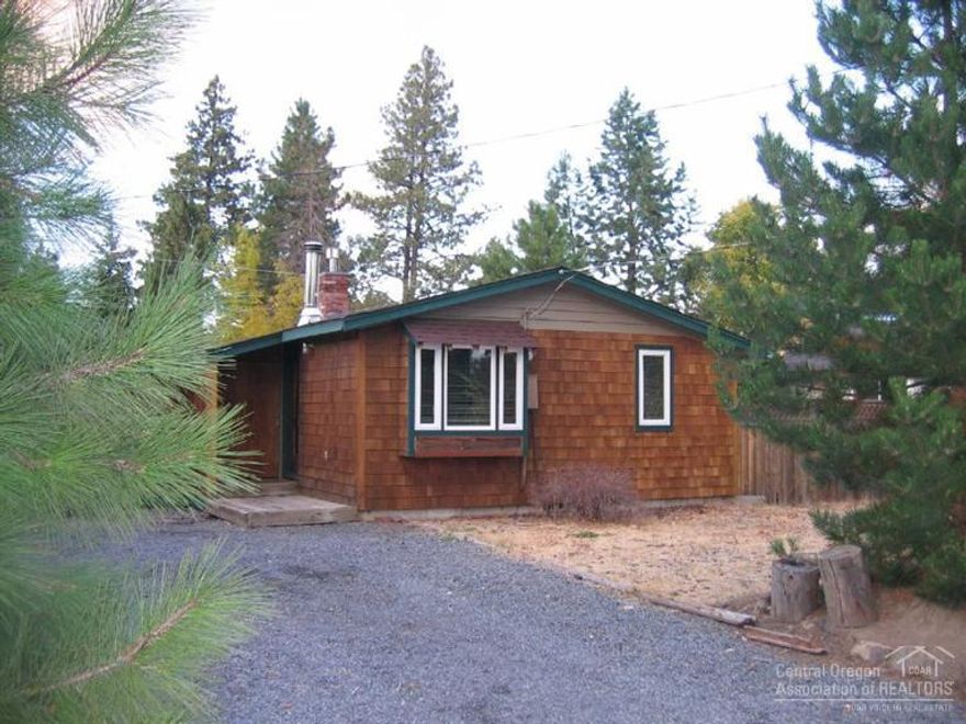 Hard to find in-fill lot in Bend's popular Highland Addition. .11 acre flat lot with small unfinished basement perfect for storage. Delightful kitchen w/ open shelves, bar area, dining nook. Gas furnace & cozy woodstove to warm you up after a day skiing. Perfect opportunity to build your dream home & be near all Westside amenities. Off-street parking. Alley-access depending on your plans! Home is sold as-is.