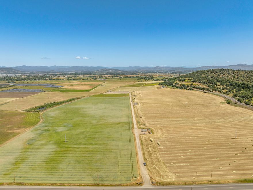 Rare opportunity to acquire 302.22 acres of productive irrigated farmland in Southern Oregon, with 287 acres of water rights from Medford Irrigation District and Rogue River Valley Irrigation District. Mostly Class III soils and a practical layout support efficient farming across nearly 300 tillable acres. The property includes three-phase power at multiple points, partial gravity-fed irrigation, and Medford city water to the farm shop and fill stations. The 4,880± sq ft headquarters includes office space, break room, bathroom/shower facilities, storage, and 3,200± sq ft of shop space. Additional infrastructure includes a barn and general-purpose outbuildings. Zoned EFU, with two legal parcels and potential for one or possibly two homesites (buyer to verify). Located just outside Medford, this large-scale holding blends strong water resources, infrastructure, and accessibility—offering excellent potential for agricultural production and long-term investment.