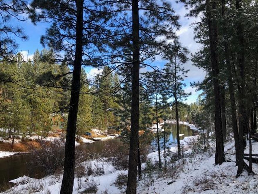 Riverfront property for sale on pristine Spring River. Paddle your kayak downstream, into the Deschutes River, past Sunriver to the Benham Falls takeout. The .61 acre lot is on a paved road, with 85 feet of river frontage and stairs down to the dock, which is shared with neighbor, and 85' wide at the street. There is also a gated community boat launch just down the road. Property has well and power in place, and septic approval from Deschutes County. Mature Ponderosa pines on the lot will make for the perfect wooded home, and it is less than two miles to the entrance to Sunriver, 18 miles to Mt. Bachelor, and 19 miles to Bend. Lot is marked 540 on the plot plan shown.