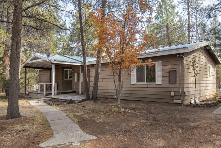 Huge Potential with this 1 acre property in Anderson Acres down in La Pine.  Situated in a quiet neighborhood with plenty of privacy, this property has lots to offer.  With an open dining/living area, lots of windows, and vaulted ceilings, this house feels open and inviting.  Newer metal roof and and oversized covered back deck are a huge plus.  Large detached shop with high ceilings provides plenty of space for all of your toys and hobbies.  Ample outdoor parking and enough room for a trailer, RV, boat etc.  With a little TLC and some updating, this property could be a great investment opportunity.