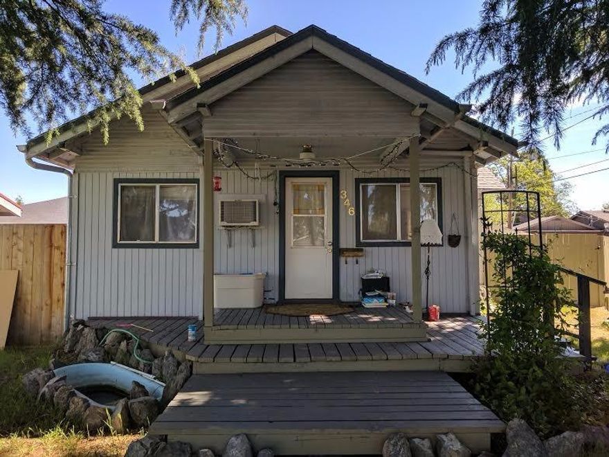 This cottage sits off the road and has mature trees surrounding and shading the home. This 2 bedroom/ 1 bath home in Central Point has a large living room, small dining area as well as two bedrooms and a bathroom. There is also indoor laundry. Outside you will find gardens and lawns that offer a great place to relax. There is even a two car detached garage.