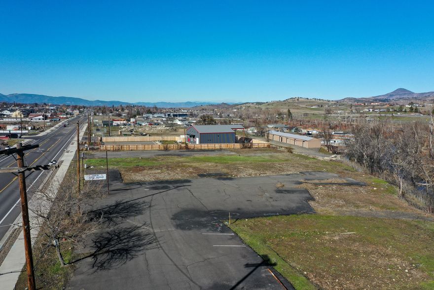 Price  Drastically Reduced. Large .67 / acre lot consisting of two parcels zoned Highway Commercial. Located directly across the street from the Crown Market on busy Highway 99 with over 20,000 vehicle trips per day. Easy access allowing for semi truck delivery.Both lots are level and have all utilities to the property. 5 minutes to Interstate 5. 10 minutes to the Ashland Plaza.  Unique property with views of Grizzly Peak, the Bear Creek Greenway and Bear Creek itself. This property has fantastic development potential. The property has been surveyed and annexed into the City of Talent. Street trees are planned to be planted in the fall of 2024. These are fantastic lots.