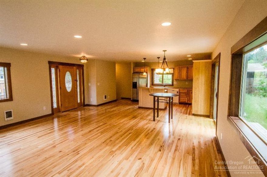 Almost new after extensive remodel. 90%+ new home custom designed by Awbrey Butte's Vern Sexton. The great room floor plan is very bright with recessed lighting, hickory floors, Milgard windows, hemlock trim with full window wraps and hickory cabinetry. The yard is fully fenced with a private back patio and room to park your toys. The remodel included NEW: Composite roof, James Hardie lap siding, roof truss system, all electrical wiring, electrical panel and all new interior finishes. Call Today!