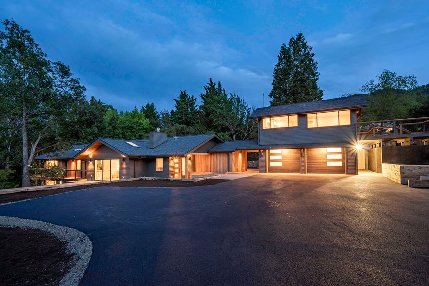 One-of-a-kind estate with two mid century residences thoroughly remodeled by renowned local architect Carlos Delgado and Mark Lackey of Integrity Building Contractors. Exceptionally rare two-acre parcel includes over 300+ feet of Paradise Creek frontage with massive granite boulders, mature trees, orchard, and gently sloping pasture with barn and stables. For an integrated experience with the outdoors, residences feature walls of glass doors and windows, sustainable hardwood decks, and expansive poured concrete patios with both Northern and Southern exposure. The main home's interior features wide-plank white oak floors, artisan tilework, cherry cabinetry and built-in shelving, open-concept great room and gourmet kitchen, along with a luxurious and spacious primary suite — all with designer fixtures and hardware throughout. Guest apartment (ADU) complete with kitchen and living area, bedroom, full bathroom and laundry. Inquire for details of construction and development potential!