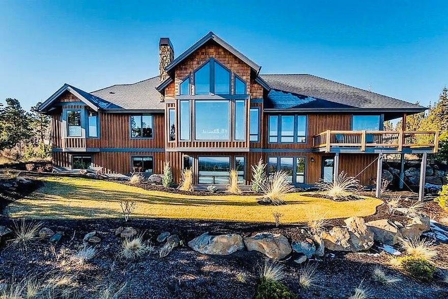 From the minute you walk in beautiful iron doors the views await!  Gorgeous modern craftsman perched on Awbrey Buttes best street.  This home offers spectacular views of the Cascade Mountains and Smith Rock.  The dramatic great room with vaulted mahogany wood ceilings welcomes you into open living spaces, a chef's kitchen, expansive office space, two bedrooms on the main level, including the master suite. The spacious primary suite includes a luxe bath, radiant floors, and a walk-in closet.   Perfect for families, the home features views from every room with a sun-filled lower level.  Generous entertaining areas, a theater room, three bedrooms, and abundant storage. Three-car garage, two large lawn areas, and natural landscaping complete this exceptional family home.   The wrap-around deck and entertaining areas will keep you outdoors all year long. On School route so street is plowed in the winter, L-shaped driveway has a minimal incline for safe snow driving. SONOS system throughout