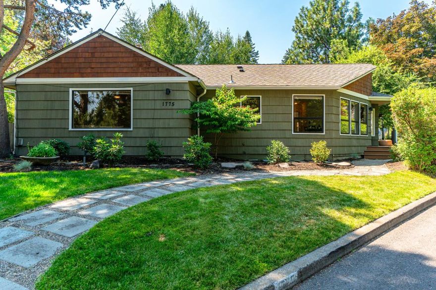 This light-filled ranch home is tucked on a corner lot in old Bend between towering pines and the rushing Deschutes river. Here, a bespoke design and walls of windows are complemented by hardwood floors, fresh white paint and tastefully updated accents mixed in with original mid-century elements. The living room is the heart of it all, with space for a variety of furnishing layouts, uses and designs. Or, retreat to the primary suite, complete with a sunny ensuite bathroom and private access to the backyard. Practical and endearing, the home offers two additional generously sized bedrooms, a separate office, basement storage, one car garage and an easily accessible laundry space. Listen to the soothing sounds of rushing water from every outdoor space on this large lot and enjoy morning walks on the river trail, access for which is just a few hundred feet away. Zipping either downtown or over to Newport avenue for a bite to eat is a breeze, making this the epitome of Bend living.