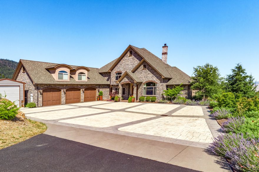 Stunning, European style home with knock out views of the surrounding mountains & Emigrant Lake. Perched on a knoll top, this gated estate has ultimate privacy without being too far from town. Quality materials used throughout the home include Venetian Plaster walls, extensive hardwood, tile & wrought iron detailing. Dramatic entry and two story great room; wall of windows & floor to ceiling fireplace. Main level owner's suite w/ impressive walk-in closet, spa-like bathroom & sauna. Gourmet kitchen features rainforest marble countertops, top of the line appliances & incredible storage. Formal and informal dining. Upstairs features a secondary en-suite bedroom, huge recreation room with wet bar and office/fourth bedroom. Exterior boasts tasteful stone and concrete detailing, plentiful flowering trees and shrubs. Raised garden beds, dog yard and more. Adjacent to the three-car garage is a temperature-controlled wine room, workshop + a detached RV shelter.