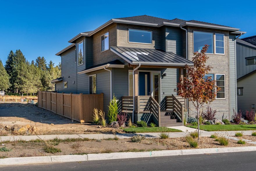 Stunning 4-bedroom home, completed in May 2025,  with no HOA dues! Beautifully landscaped with covered front deck entry. This great room floorplan is light & bright, w/large picture windows, automated window blinds & gas fireplace with tile surround & mantle. Gorgeous hardwood floors on main level.  Office/flexspace has French doors & walk-in closet. Spacious kitchen boasts oversized island with ample storage, quartz counters, full tile backsplash, ss KitchenAid appl. including a steam/bake/convection range double oven. Covered back patio, fenced & gated backyard. Large mud room off the 2-car garage that features new polyeurea flake flooring. This Earth Advantage home boasts tankless water heater, AC, & gas forced air heat.  Expansive primary suite offers big picture windows w/automated blinds, tall counters, dbl. vanities, tiled floors & shower and walk-in closet. Laundry with sink/cabinets. Quiet setting in Countryside neighborhood, close to schools, Alpenglow Park & Bend Golf Club.