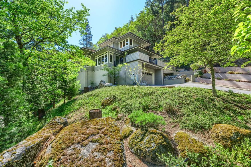 Style meets sophistication in this beautiful architecturally designed home located on a large treed lot overlooking Lithia Park with soothing sounds of Ashland Creek flowing by.  Private entry leads to a very user friendly and well laid out floor plan.  The master suite, kitchen, dining area, office and half bath are all on the main level, two additional bedrooms and bathroom are upstairs.  Many impressive, large windows throughout the home allow for an abundance of natural light to pour in while perfectly framing the outside surrounding views.  The chef's kitchen is spacious, has a massive granite counter top island, high end quality stainless steel appliances and lots of storage.  Master bedroom en-suite has two walk-in closets, large bathroom with dual vanities, steam shower and a lovely soaking tub with a view.    Office is attached, yet this room and set-up can be changed providing versatility depending on one's needs.  Huge garage with tons of storage.