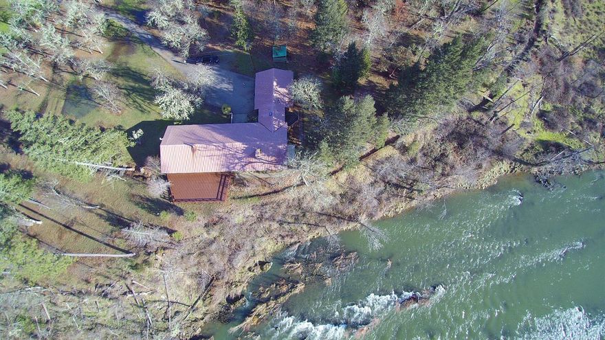 At nearly 3/4 of a mile river frontage, this private 99.66 acres will exceed your expectations with all it has to offer. Nestled along the beautiful Illinois river, close to town, but with a total country feeling. Coupled with 62.1 acres of water rights and loads of land the possibilities are endless; cattle, horses, farming, vineyard, multifamily set up or weekend retreats. The main home is 2974 sq/ft, with abundant windows to take in the majestic river views. Four of the bedrooms have sliding glass doors that go out onto a 1000 + sq/ft deck that looks right down on the river. There is a legal 560 sq/ft rustic cabin, a non-conforming workhouse, multiple outbuildings, barn, cattle corral, older concert tennis/basketball court, epic swimming holes, 3 phase power to main 40 hp irrigation pump, fully fenced & cross fenced. To much to list, call for your tour today. Information deemed accurate, but not verified. Buyer to do own due diligence regarding all aspect & uses of this property.