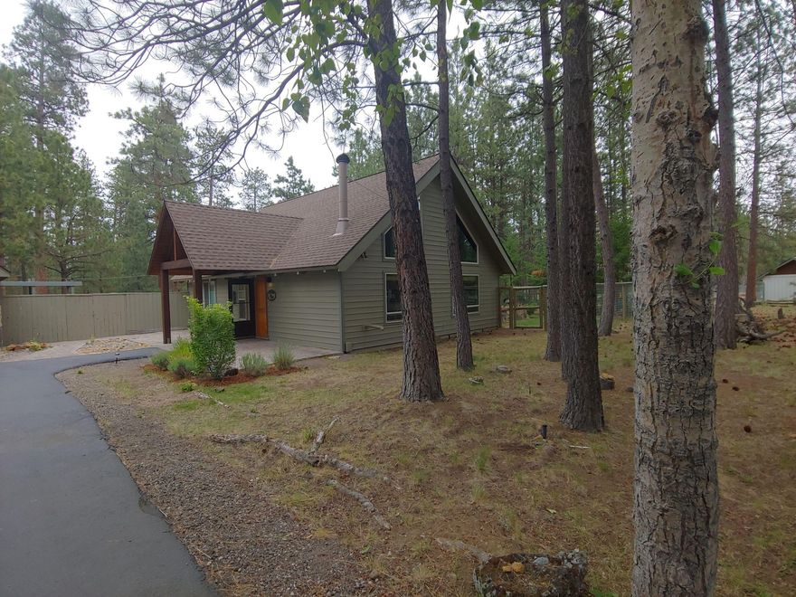 Private, half acre, end of the cul-de-sac & bordering Forest Service, this quaint 2 BR, 1 bath home (1316 sq ft) is ready for your move to Tollgate.  Vaulted wood/beamed ceilings in the great room has views looking out to the towering pines.  One bedroom on the main level has access to the outside, with a larger loft bedroom upstairs.  Functional kitchen with built in pantry, granite slab counter/breakfast bar.  Detached garage has separate entry to home office/studio (aprox 270 sq ft).  Access to 3/4 bathroom through garage or studio.  Potential living area above or extra storage via pull down ladder.  Separate water htrs for studio/home.  Fenced yard, patio, deck, paved driveway.  Shown by appointment.