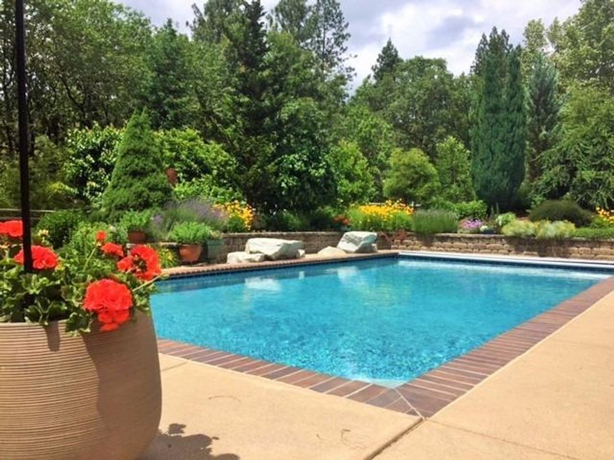 Gorgeous custom home by Dave Adams. 6.19 ac privacy just minutes from town. Liv rm has a 20' open beam ceiling w/soaring windows & abundance of light. This home is positioned perfectly, enjoy mountain views, morning sun & sunsets. Gourmet kitchen, granite counters & large butcher block center island. Main floor master bedroom w/private balcony & views. Lower level is a large family rm flanked by 2 generous size bdrms & two full baths. All bdrms include walk in closets. Separate mud room entrance w/specially designed dog-wash. Extensive storage throughout! Poolside,is a lovely guest quarters w/full bath for extra family or guests. Hobby rm above garage is a great place for crafts or extra storage. Large heated pool surrounded by gardens, flowers, beautiful trees & seasonal creek. Property is fully irrigated w/individual timers, sunny garden area, plus approx. 4 acres crossed fenced for animals. Property zoned r-12 w/potential to subdivide. Without question a very special property!