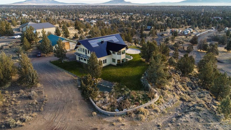 European engineered home is self sustaining & green built - truly one of a kind w/ 360 degree views from the Cascades to Smith Rock, Ochocos & beyond. A grand entry foyer w/central spiral staircase leads to the 2nd floor. Main living area is open & inviting w/ floor to ceiling glass on all sides. Open kitchen w/Cherry cabinets, modern range hood & amazing view of the pond & Smith Rock beyond. Living area opens to outside for yr round entertaining. Main level Master Ste & west facing Bonus room. 2nd floor offers a 2nd Master, 2 bedrooms, 2 baths & attic access for additional 600 sf storage space. ICF construction, radiant floor heat, solar system, passive cooling, ultra efficient, green built home! Imported glazed tile roof, marble accents, water storage system w/private well. 36x48 shop w/heated floor, plans for garage & some materials. Expansive lawn, auto sprinklers & Koi pond, room for horses & miles of trails nearby. Main floor 2050sf, 2nd fl
