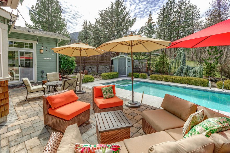 This stunning single-level Ashland home sits on a serene .45-acre lot with a park-like atmosphere. The interior boasts a stylish and functional kitchen with granite countertops, hardwood and tile flooring, solid wood doors, and plenty of natural light. A cozy family room with a Tulikivi masonry fireplace and a formal dining room make for great entertaining spaces. The master suite and hall bath have been beautifully remodeled.


This home offers seamless indoor-outdoor living with an inground pool and spa for summertime fun, covered patios and a vaulted, beamed sunroom for relaxation, and easy access to the pool and two bedrooms. The cul-de-sac location features an automated gate, RV parking, and lush landscaping with fruit trees and raised beds. Whether you want a peaceful retreat or a space to entertain guests, this home has it all.