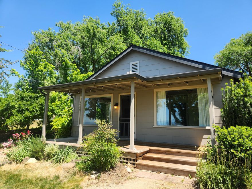 Wonderfully updated Cottage style farm home, situated on 1.25 acres. The living and kitchen areas have been completely remodeled from the studs up, with new sheetrock, laminate flooring, electrical, kitchen cabinet and granite counters, fixtures and dishwasher. Both bedrooms have built-ins, indoor laundry and a bonus room off the back of the home. A newer septic system, newer roof and a great well producing approximately 9 gallons per minute according to the seller. The property is level and has TID irrigation. Detached garage and an 8X12 shed. Plenty of fenced space for animals and a garden area. This rural property is ideal and within approximately 10 minutes to either Medford or Ashland. Enjoy watching the sunsets on the covered porch!