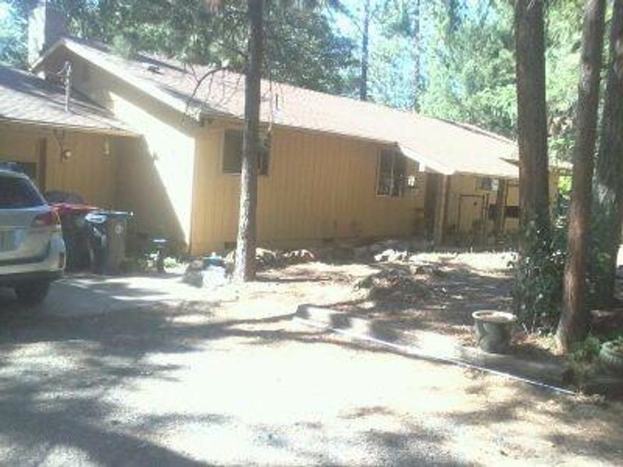 Cute, Single-Level Home on a Flag Lot With Awesome Views! You will love this Jacksonville starter on a huge 0.577-acre lot with low-maintenance, natural landscaping and loads of trees that keep the home cool throughout the day. Located in a quiet neighborhood, just up the road from Ruch Elementary School, close to the park and all the recreation that Jacksonville has to offer including the Britt, shopping, hiking, Applegate Lake and River! Take in the views of the valley and mountains from the big deck in the huge back yard. The sturdy privacy fence surrounding the property helps keep the home critters in and the wild ones out, and there's an abundance of parking space. The home offers lots of storage and counter space with a large, sunken living room with sliding doors to the deck, and separate dining room off of the kitchen. Priced to sell, so tour it soon!