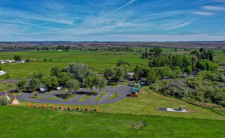 Burns Good-Sam RV Park on 7.6+ Acres Bordering the Silvies River! One of the cleanest/functional RV parks around with a positive cash flow – 11 Cap Rate! 50 full hookup sites, 22 pull thru spaces, 20 back in's & 15 metered sites for mo/mo rentals! 1100sf 3Bd/2Ba onsite Manager's/Caretaker quarters, check-in office, separate shop, 2-guest cabins, 3-tee pees + tent sites as well! This park is in pristine condition w/park areas, fire pits, bar-b-ques and two bathroom/showers/laundry room locations in the park! This RV Park has been a natural rest stop for travelers between Central Oregon & Boise with a substantial customer repeat business & High Good-Sam Club Rating!