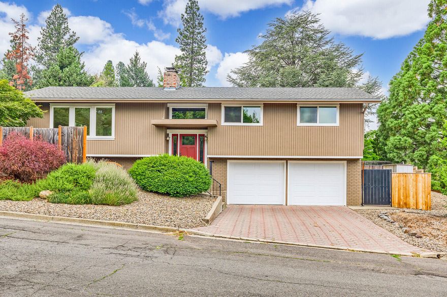 Located on a spacious corner lot in a highly desirable Mountain Ranch neighborhood, this thoughtfully maintained home is bright, clean & move-in ready!  Comfortable & appealing 2-story, split level, freshly painted inside and out, featuring a versatile floorplan, skylights, brick fireplace, and pleasant mountain views.  The main level offers a peaceful primary bedroom w/ bath, 2- additional bedrooms & hall bathroom, open living room w/ window seats & brick fireplace, kitchen & dining area w/sliding door overlooking fully fenced & beautifully landscaped backyard with large stone patio.  The lower level offers a 4th bedroom, bath, laundry room and a cozy family room.  A fully landscaped yard, TID irrigation, attached double-car garage & easy access to the fabulous Oredson Todd Woods & fabulous hiking trails complete this wonderful property.