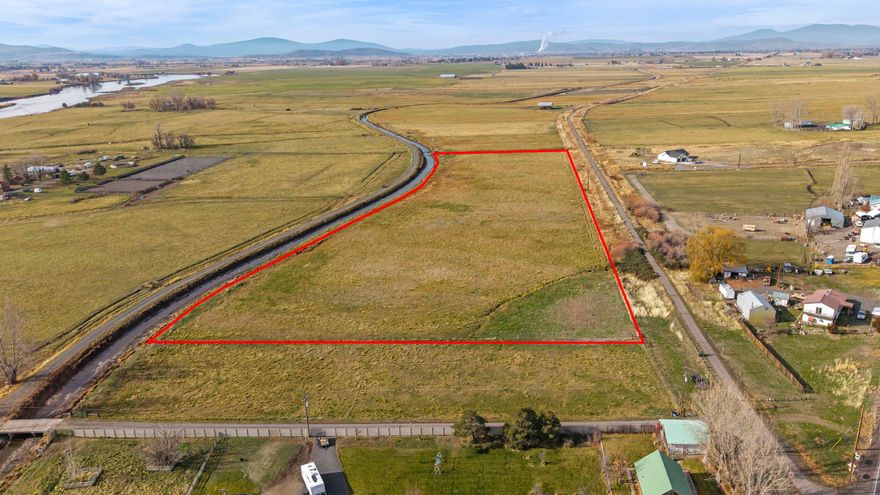 The one everyone wants! 10+ acres, minutes from town, prime school district with room to expand. Flood irrigated from district, fully fenced and equipped with a well already. This location is ideal; situated back from the road but not too remote. Run some cows, 4-H animals, etc. The 1.5 acre lot connected to this can be sold as well, it is already zoned for residential so you could build your dream house & still have plenty of room.