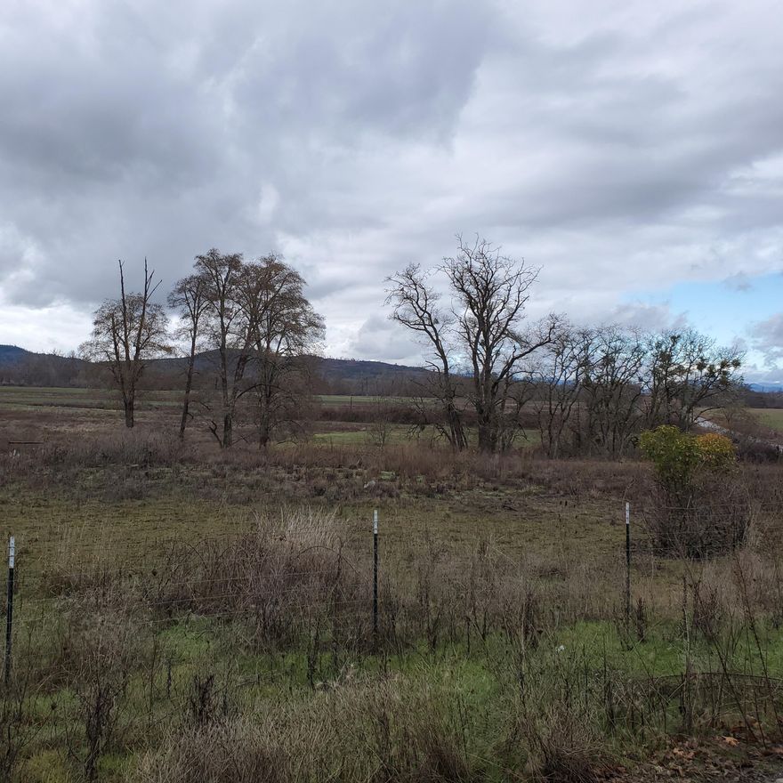 1.70 acres zoned EFU with Rogue River Valley Irrigation District water rights!  This will be a labor of love project to prepare your country retreat that is a short commute to Eagle Point and Medford.  Stone Ridge Golf Club is just five minutes away too.  1930's cottage and 1963 single-wide currently on parcel.  Value is in the land.  Build your new home in a serene rural setting or place a new manufactured home here.  Interested buyers need to complete due diligence with Jackson County to ensure compliance and feasibility for their future plans for this great opportunity!