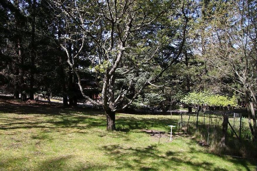 Gently sloping lot nestled among the oaks, pines, madrones, and flowering shrubs. It is located on a quiet cul-de-sac, just above the boulevard near Southern Oregon University. Bring your builder and create your dream home or hold for investment.