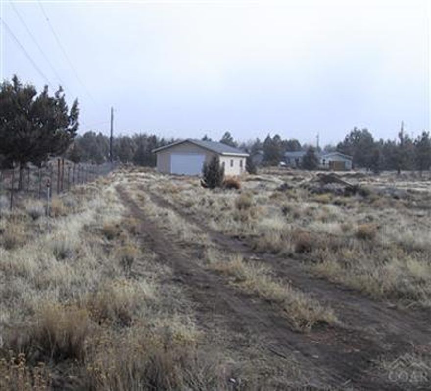 Private 1.25 acre cul-de-sac location with Cascade Mt Views. This lot is ready to go! Septic is installed with a 1000 gallon tank. Connection to Crooked River Ranch water, with backflow device in place. 30 x 40 garage/shop with concrete floors, window and a 16 x 10 overhead door. Just add your dream home and enjoy all the amenities Crooked River Ranch has to offer.