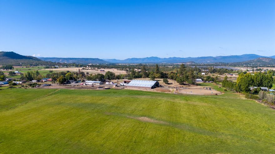 Equestrians dream! Two homes! Main home was tastefully remodeled in 2016 with new floors, appliances, black leather granite, soft close cabinetry, new roof in 2021 & is currently being painted! Features 3 bed/2 baths, an office, good sized master bathroom w/ oversized soaking tub, fenced yard & a front porch perfect for watching the incredible sunrises over the hay field! 2nd home completed in 2019 - 3 bed/2 baths, open floor plan, large kitchen/dining/living room, good sized bedrooms, primary bedroom w/ huge bathroom & walk-in closet! 15 stall barn w/ 60x120 indoor arena, a kitchen, bathroom & two insulated tack rooms. 150ft round outdoor arena, 60ft round pen, hay storage, a covered wash rack w/ hot/cold water & heat lamp. Property completely fenced w/ multiple turnouts & has an additional barn w/ a few stalls, small shop, chicken coop, a great garden & small orchard! Irrigated acreage produces 50 tons of hay with one cutting. Great well! Tons of water! Schedule your showing today!