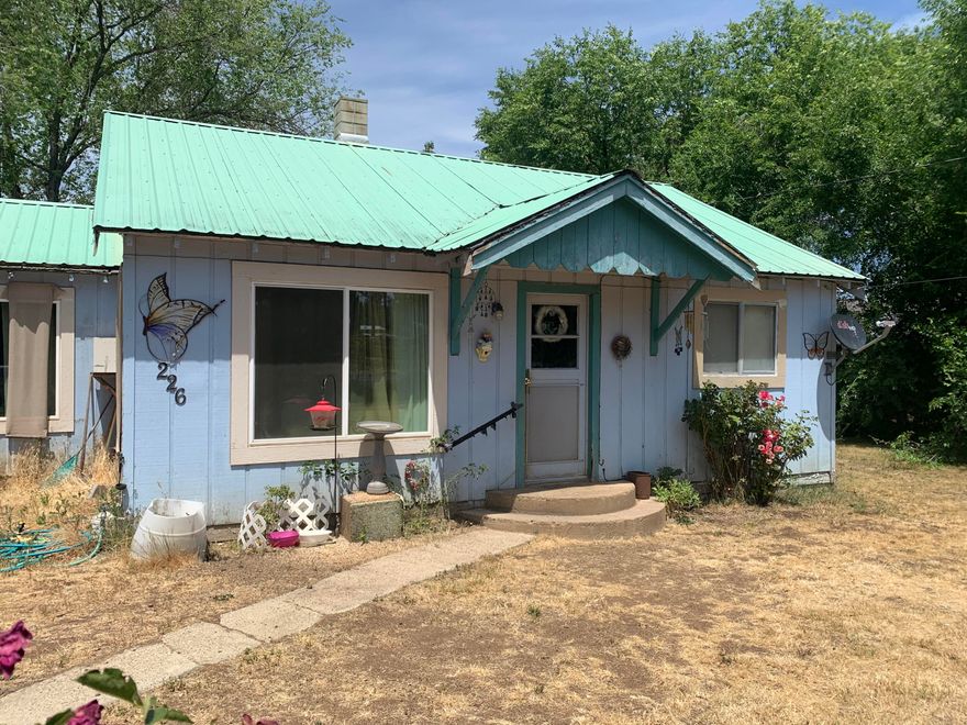 Here is your chance to purchase a property with so much potential for increased equity after a bit of work to the home. Just under 1 acre, .90, fenced and level for animals or storing your extra trailers, equipment or RV's. It has a country feeling yet close to shopping and town. The Home is a 1172 sf, 2 bedroom and 1 large bathroom. very cozy and comfortable to live in as you make any repairs. There is an additional shop/storage/possible ADU behind the home needing some attention. This property has huge potential for increased equity with a few simple remodel/repairs made.

Priced for a quick Cash Sale.