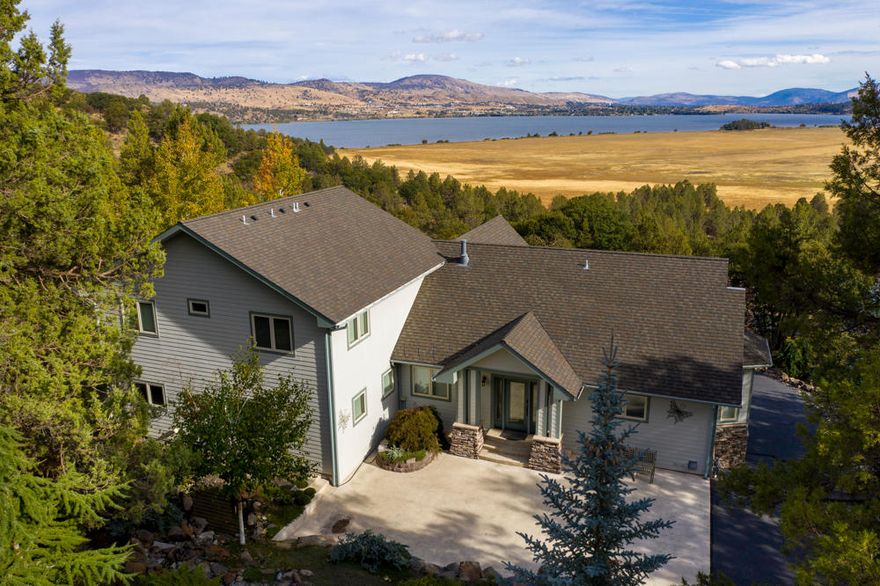 Located within the Running Y Ranch Resort in southern Oregon, this magnificent home offers stunning views of Klamath Lake, the Cascades, ranch lands, sunrise and city lights.  Almost an acre of mature landscaping, the water feature and surrounding common areas welcome you to a serene enclave, a special retreat. The home features 3 levels of living space with the main floor boasting a great room with floor to ceiling stacked stone gas fireplace, built in bar, powder room, spacious master suite with oversize master bath, gourmet kitchen and a convenient dining area and breakfast nook. Also on the main level is an office designed for two, laundry room and a flex/hobby room with counter tops and abundant natural light. Each bedroom is en suite, with heated tile floors. The guest room level boasts boasts a gathering space for media and games.  Custom features throughout plus a 4 car garage.