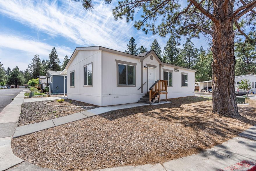 Located on a corner lot in The Pines! This 2021 manufactured home with 3 bedrooms, 2 full baths & 1296 sq ft of living space offer a light & bright open floor plan. The home features a nice sized kitchen w/ all ss appliances, full tile backsplash, kitchen island, pantry & coffered ceiling in dining area. In the sizable primary suite you will find a walk-in closet, shower stall & a double vanity. Outside there is a covered carport & storage room. The park space fee of $1000.00 a month includes snow removal, clubhouse access, play court area, & maintenance of common areas. All occupants must undergo park approval, including a background & credit check. Contact your realtor today to schedule a showing!