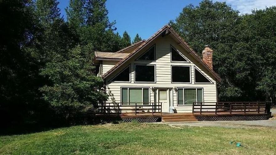 Your perfect chalet in the country. Just minutes outside of Grants Pass is this custom built lodge style home, with its own working shop. Grand cathedral ceilings with balcony. Master bedroom on the main floor with open kitchen that is great for entertaining. Very well built with carport area and enjoy the deck that looks into the grassed treed area. Nice large windows bring in the nice light from the sun. Two accesses to this home, one for the shop and one for the house or use both. The shop is fully contained with an office/room upstairs so a home business or hobbyist will enjoy this. There is a setup for another home/manufactured that has its own hookups and utilities. All flat land and nicely treed this stand out house will make someone happy to call home. Ready for move in.