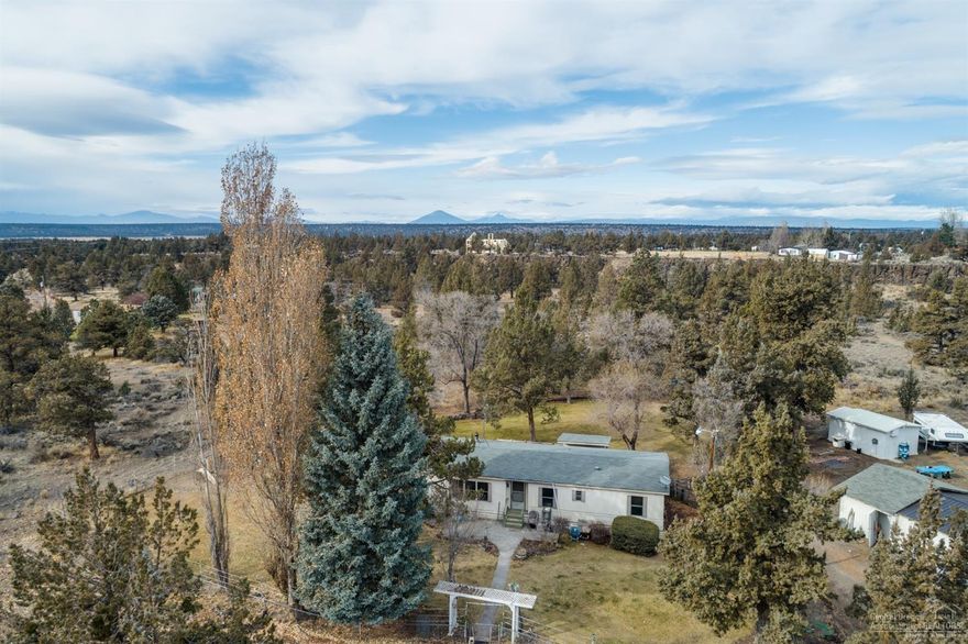 Opportunities abound on this beautifully landscaped 5.02 acre property in desirable Tetherow Crossing in Redmond. The property features a 1978, 1403 sq. ft, 3 bed and 2 bath manufactured home, detached garage/shop and shed. The area around the home is fully fenced and has been irrigated, the remainder of the property is natural high desert terrain. Cascade views from the on the northwestern side of the property. Tetherow Crossing neighborhood provides easy access to BLM and the Deschutes River.