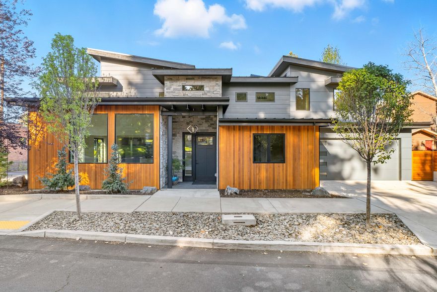 Discover modern living - a stunning new construction near downtown and Drake Park. Set on an oversized corner lot, this 3,093 sq ft home (plus 466 sq ft garage) offers 4 bedrooms, 3.5 baths, and a bright, open layout designed to connect seamlessly with the outdoors. Walls of windows fill the living spaces with natural light, while tiled patios and covered decks invite year-round enjoyment. The chef's kitchen features maple cabinetry, quartz counters, custom hood, island, pantry, and premium finishes throughout. A rare opportunity to own a contemporary home in Bend's prime westside neighborhood reimagined with timeless design.