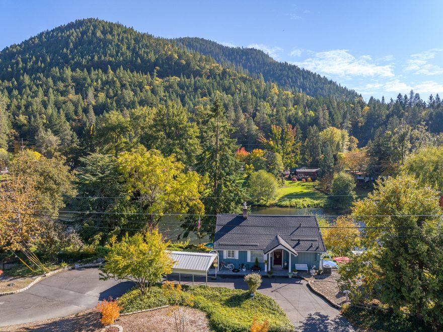 Riverfront living with endless possibilities! This multi-level bungalow offers incredible flexibility and stunning views of the Rogue River. Featuring two master suites—one on the main level and one on the lower—each with a jetted tub, this home is designed for comfort and versatility.  Main level features hardwood floors, full kitchen, and open living area with a spiral staircase leading to an open loft with 4 queen beds, while the lower level offers separate kitchenette with cooktop and access to an exterior tiled sitting area.   Step outside to the spacious Trex deck with glass railing overlooking the terraced backyard with 8-person fire pit and direct river access—fish, kayak, or simply relax by the water. Multiple outdoor areas, gated entry, RV parking, and updates including new roof, HVAC, and fencing make this the perfect full-time home, vacation getaway, or short-term rental opportunity.