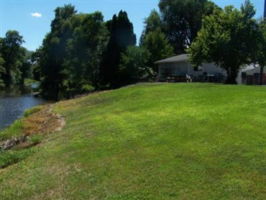 103 feet of creek frontage. This 0.33 acre flag-lot is partially level and gently slopes to Little Butte Creek. Would make great investment or 2 family set-up. Includes 22x24 shop.