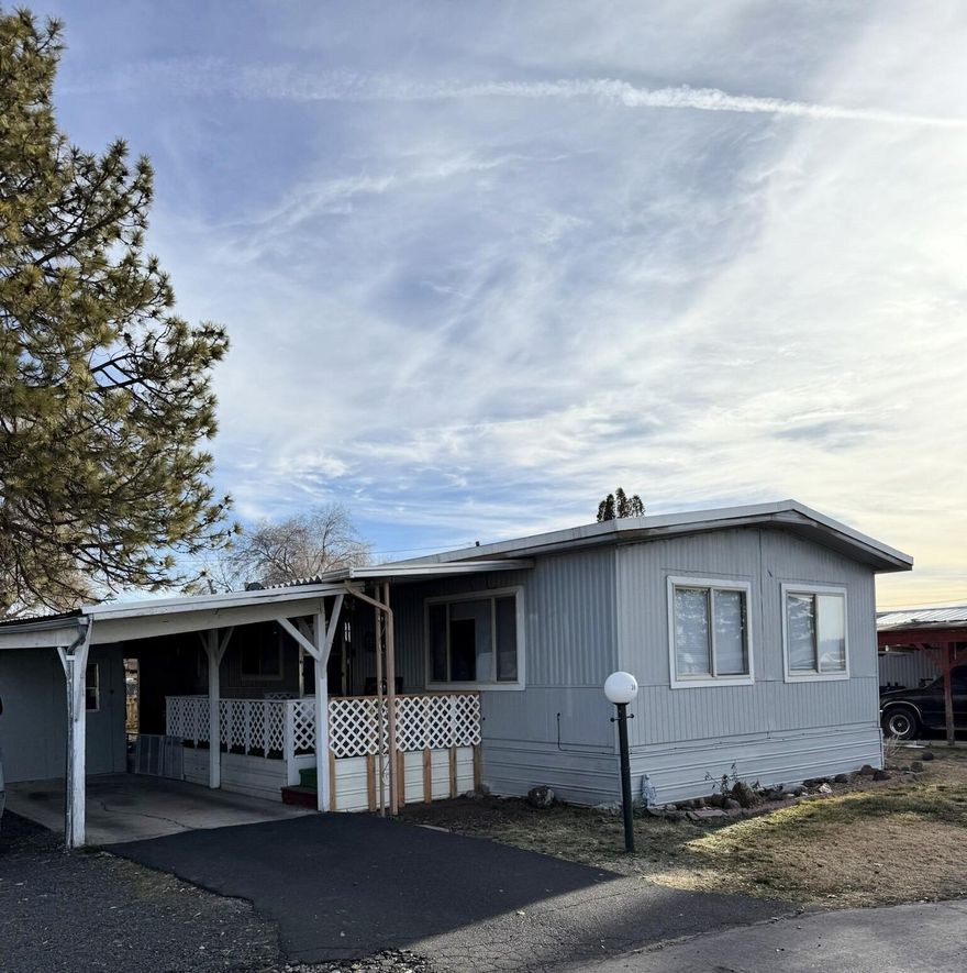 New carpet in nice two bedroom one bath manufactured home in established park. Large bedroom with walk-in closet. Walk in shower. Covered carport parking and porch. External storage area with fenced back yard. Buyers must be approved through the park.  Park offers RV parking for an additional fee. Space rent is $630.09. Includes water, sewer and trash. Park has a dog policy.