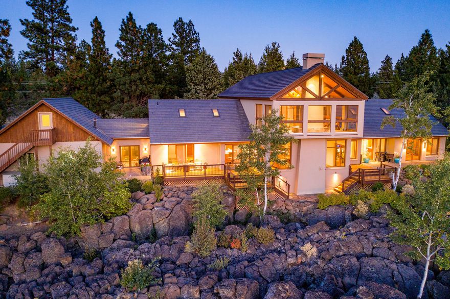Appreciate this custom home with panoramic views from Broken Top to Mt Jefferson. Fronting permanently protected land, this home over-looks Whychus Creek and the Willow Springs Preserve. Wildlife frequently stroll through and you'll watch raptors hunt as you gaze through mature Aspen trees springing from exquisite lava flow outcroppings. Evening sunsets and morning light breaking on the seven mountains create magnificent views.The spacious, open concept plan offers sun-lit, relaxed spaces. A Three Rivers Stone wood-burning fireplace sets off the Great Room for relaxing living and entertaining.  A chef's kitchen features an island, extra sink and a walk-in pantry. The main level bedroom has it all, breathtaking mountain views, walk-in closets, en-suite bath and hot tub. Upstairs you'll find another living space complete with kitchenette, bedrooms, space for games/tv, and covered porch with propane fireplace looking to the mountains.
