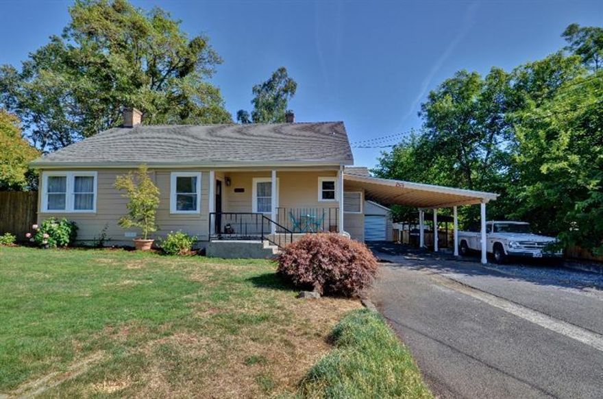 Come tour this charming 1930's home! Situated on nearly a quarter acre, this three bedroom two bath home has many fantastic upgrades including: slate tile floors, granite sink, tile countertops, refinished red mahogany cabinets, tongue & groove hardwood floors, new siding, new paint, new windows in most rooms and upgraded electrical & wiring. It has a well thought out floor plan and spacious rooms with lots of light and convenient washer and dryer hookups in the hallway closet, perfect for a stackable set. Not to mention a detached shop/garage area and beautifully landscaped backyard with a water feature.