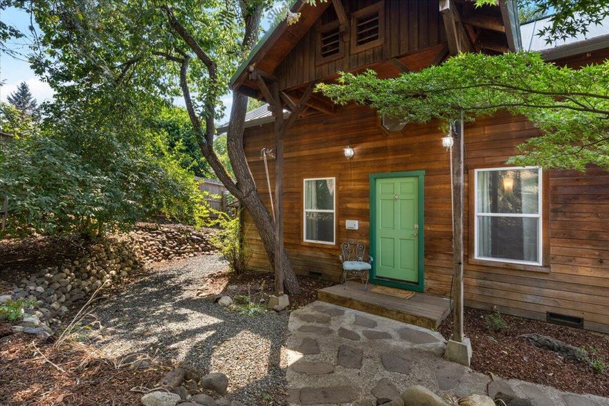 Don't miss out on this gorgeous Redwood home located just steps to the best of Jacksonville. Short walk to the Britt Gardens, J'Ville Tavern & all the amazing shops/restaurants. Main level features a large living space with vaulted ceilings, open kitchen with granite countertops, stainless steel appliances, gas range and island; step down into a beautiful space filled with large windows, priceless views and two window sitting areas, this room was previously used as the master. The main level also features an updated bathroom with heated tile floors and custom walk in shower. Upstairs you'll find a second updated full bathroom, two spacious bedrooms and brand new carpet. The grand finale is the backyard oasis featuring a massive cedar deck with two gas hookups, raised beds, sprinkler system, custom water feature and plenty of additional space. Oversized storage shed, with power, just waiting to be turned into a personal wine bar. Dedicated parking for 2 vehicles plus electric charger.