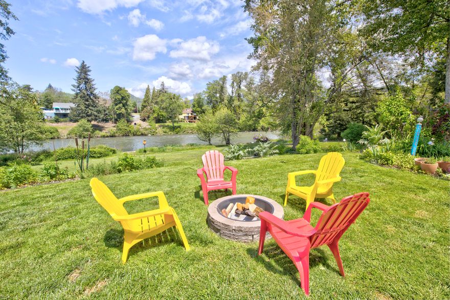 Craftsman Cottage with 1620 sqft and 2 ADU units on the Rogue River with lawn to river frontage. The Home has 3 bedrooms, including main floor Primary and Primary bath has heated floors & skylights shining on soaking tub and custom tiled shower. The kitchen range oven is a 6 burner gas stove with a convection oven and a pot filler! Stainless steel appliances highlight the custom alder cabinetry. Dramatic river views from home & exotic hardwood decks oversee the firepit and huge low bank lawn. The double garage and extra workshop include 2 ADUs... a studio unit with level accessibility and river views, bathroom, kitchen, and vaulted ceilings, the upper garage apartment includes large windows for amazing river scenes and kitchen, bathroom, with deck to the lawn.  Walk or meditate along the tranquil garden with a pond, creek waterway enveloped by maples, rhodies & azaleas. This home is surrounded by flowers, flowering plants, and trees, and ducks, geese, osprey & otters. Rare opportunity.