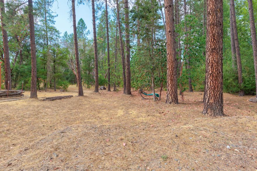 Rare chance to own a stunning, level 1.36-acre wooded property that seamlessly blends serene country living with the convenience of nearby city amenities. Located just off E Evans Creek Rd. This prime lot offers easy access to I-5, and just minutes from the town of Rogue River. Immerse yourself in the beauty of the area, where lush trees meet the flowing waters of the Rogue. Key property highlights include: Buildable lot giving you a unique opportunity to create your ideal home and workspace. Fully Functional off-grid setup is available, complete with solar, water storage, and an immaculate 2018 Custom Built Tiny Home (sold separately), established landscaping, garden area, and privacy wall in place. Lot has septic approval, and power at property line. Don't miss this chance to secure the perfect lot for your dream home and shop! Contact your realtor to schedule a private showing.