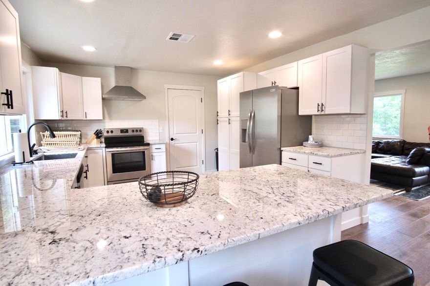 Beautifully remodeled home finished in 2020.  A laundry list of updates and upgrades within the last year include: a new 40-year roof, recessed lighting, vinyl windows, new interior doors, fresh interior and exterior paint, engineered hardwood flooring throughout, tile floors in fully remodeled bathrooms, renovated kitchen with stainless steel Frigidaire appliances, granite counters, shaker style cabinets, and a brand new central heating and air conditioning system and ducting. Property features a large front yard with mature apple and pear trees, and fenced back yard with possible room for RV. Also includes irrigation pump and water rights to GPID.