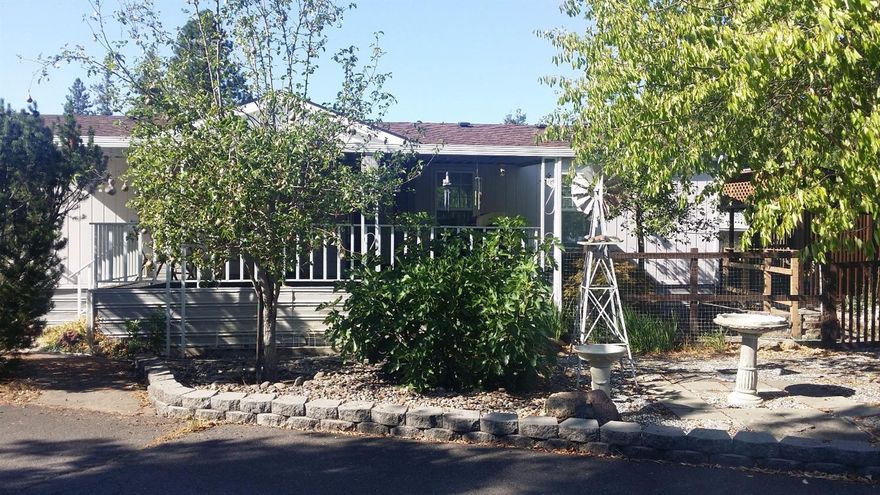 Come tour this amazing 3 bedroom, 2 bathroom spacious home on a large corner lot with mature trees for shade. Open concept living, vaulted ceiling, two ceiling fans, double sky lights in the kitchen and a breakfast nook. Large master suite with an over-sized bathtub. Covered front porch, raised garden beds with a drip system. 2 pear trees & a fig tree. Enjoy a glass of lemonade on your private covered deck. Plenty of room for all your outdoor entertaining and gardening needs. Extra storage shed complete with electric and air conditioning makes a great hobby space or workshop. Walking distance to shopping, post office, banking, and the river. Move-in ready complete with all appliances including W/D. Rent space is $315 + $86 park utility fee. You will enjoy the views and the quiet peaceful living in this 55+ Shady Cove park. Call today before it's gone.