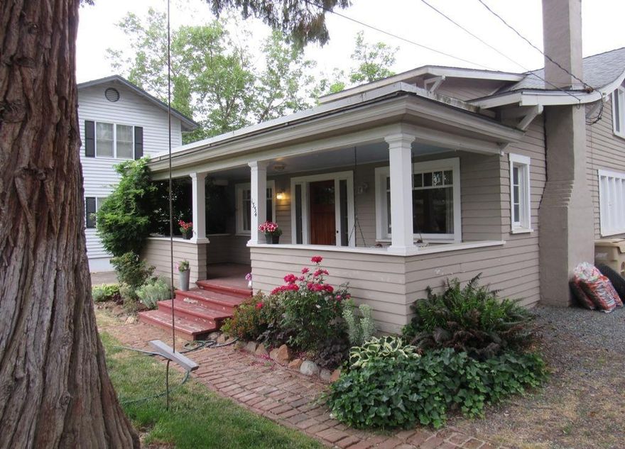 Classic, Craftsman, Charismatic, Charmer, located in one of the most desirable areas of Grants Pass. This adorable home sits back off the street on .25 of an ac. Built in 1900 it features 2 bedrooms, 2 bathrooms with an additional guest bed and bath off garage. Kitchen nicely remodeled with tile floors. Quaint dining room with glass doors and built in curio cabinets & hardwood floors throughout. Wood stove insert in living room, gas forced air heat and central air. After a hard day enjoy relaxing on the front porch watching the world go by or out back lounging by or swimming in the inground pool. Abundant storage throughout, garden beds, attached garage and RV parking too. Close to shopping, schools and downtown with District 7 schools.