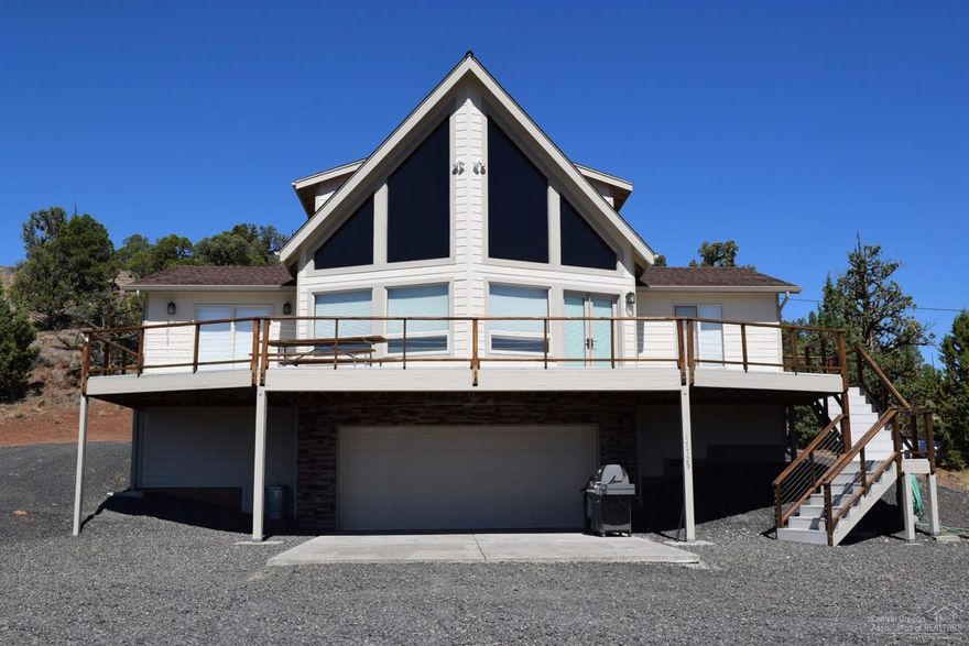 VRBO possibilities, expansive view overlooking Crooked River and Prineville Reservoir, 15.34 acres. Home features soaring ceilings of clear fir to complement the open floor plan, 1956 sq ft, 3 bed/2 bath home, 2 story wall of windows, hand chiseled cabinetry in kitchen, sauna and more. This exquisite home was built on bedrock, using steel beams on the prow. Top two levels, bottom level, garage/shop total 3,258 sq ft per Assessor. Borders BLM with beautiful trails. Huge Trex Deck for relaxing. Price is firm.