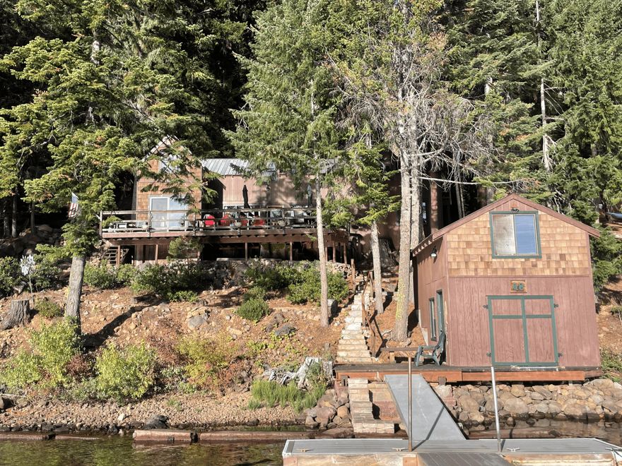 Unique Opportunity! Big cabin with 4 full bedrooms, 1 ½ bathrooms, remodeled kitchen and cozy updated for comfortable cabin life. Stone wood burning fireplace. Large deck, two story boat house with a 5th full bedroom. Storage/laundry building with washer and dryer. Boathouse to store all your fishing and tubing equipment. Large private dock with boat slip. Located on the West Side.